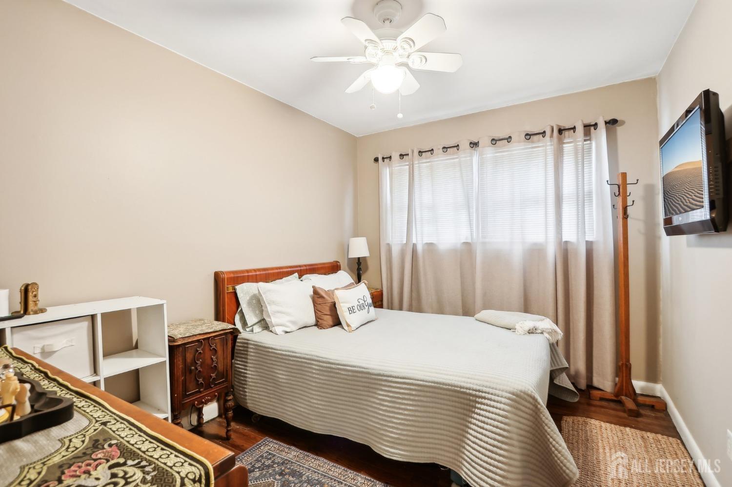 23 Brox Road Edison, NJ 08817 - Photo 9 of 33 a bedroom with a bed and a chandelier