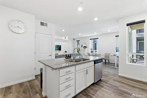 a kitchen with a sink cabinets and wooden floor