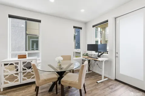 a view of a workspace with furniture and a window