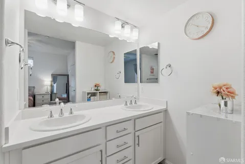 a bathroom with a double vanity sink and a mirror