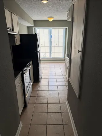 a view of a refrigerator in kitchen and wooden floor