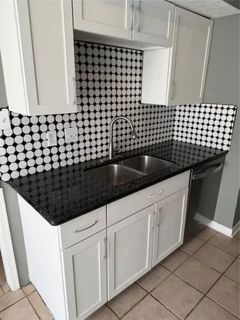 a kitchen with a sink and cabinets