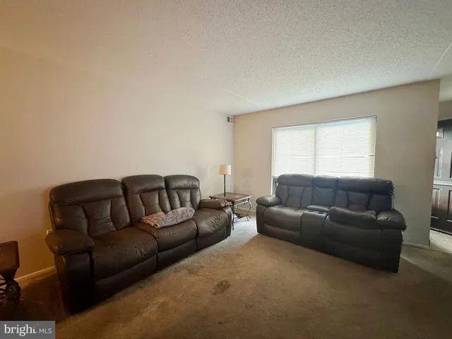a living room with a couch and a window