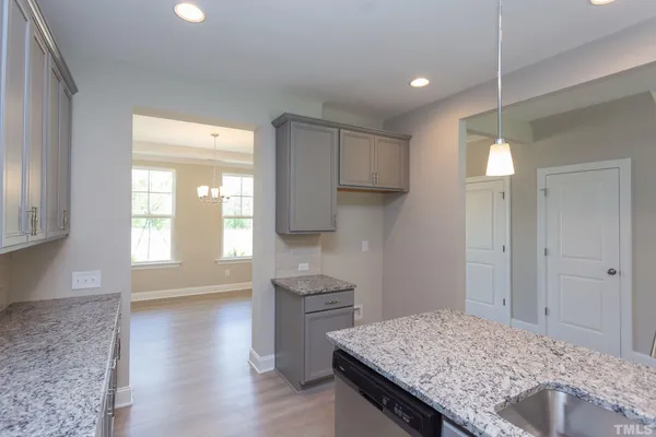 a kitchen with kitchen island a sink appliances and cabinets