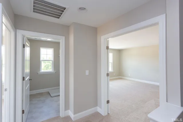 a view of hallway with bathroom
