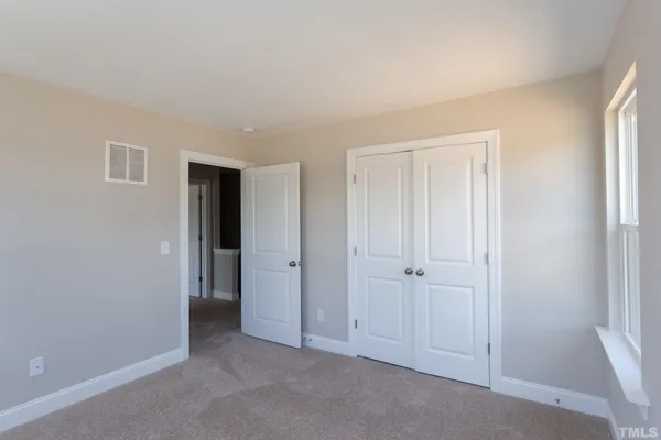 an empty room with closet area