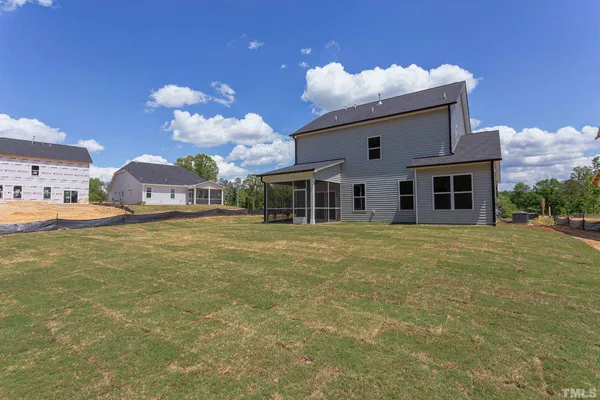 a front view of house with a garden