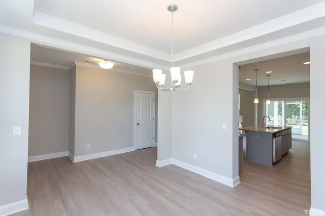 a view of a room with wooden floor and furniture