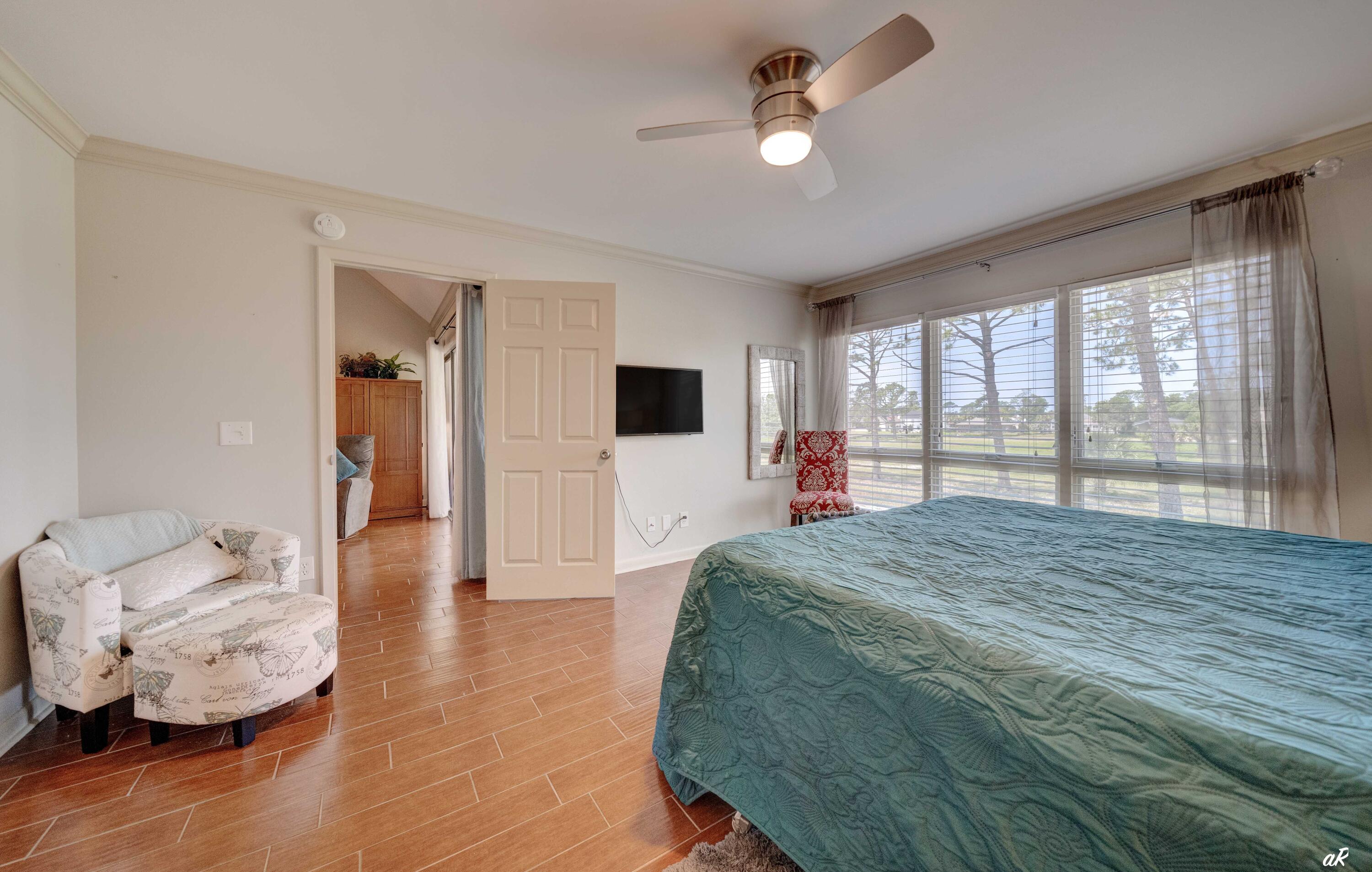 4300 Bay Point Road, Unit 417 Panama City Beach, FL 32408 - Photo 14 of 35 a bedroom with a large bed and a large window
