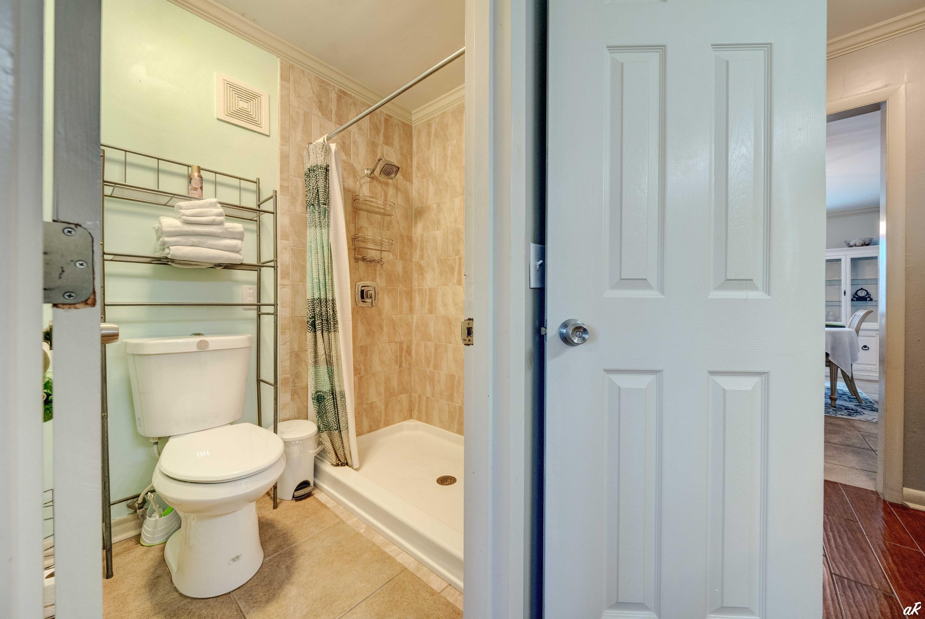 4300 Bay Point Road, Unit 417 Panama City Beach, FL 32408 - Photo 17 of 35 a bathroom with a toilet and a shower