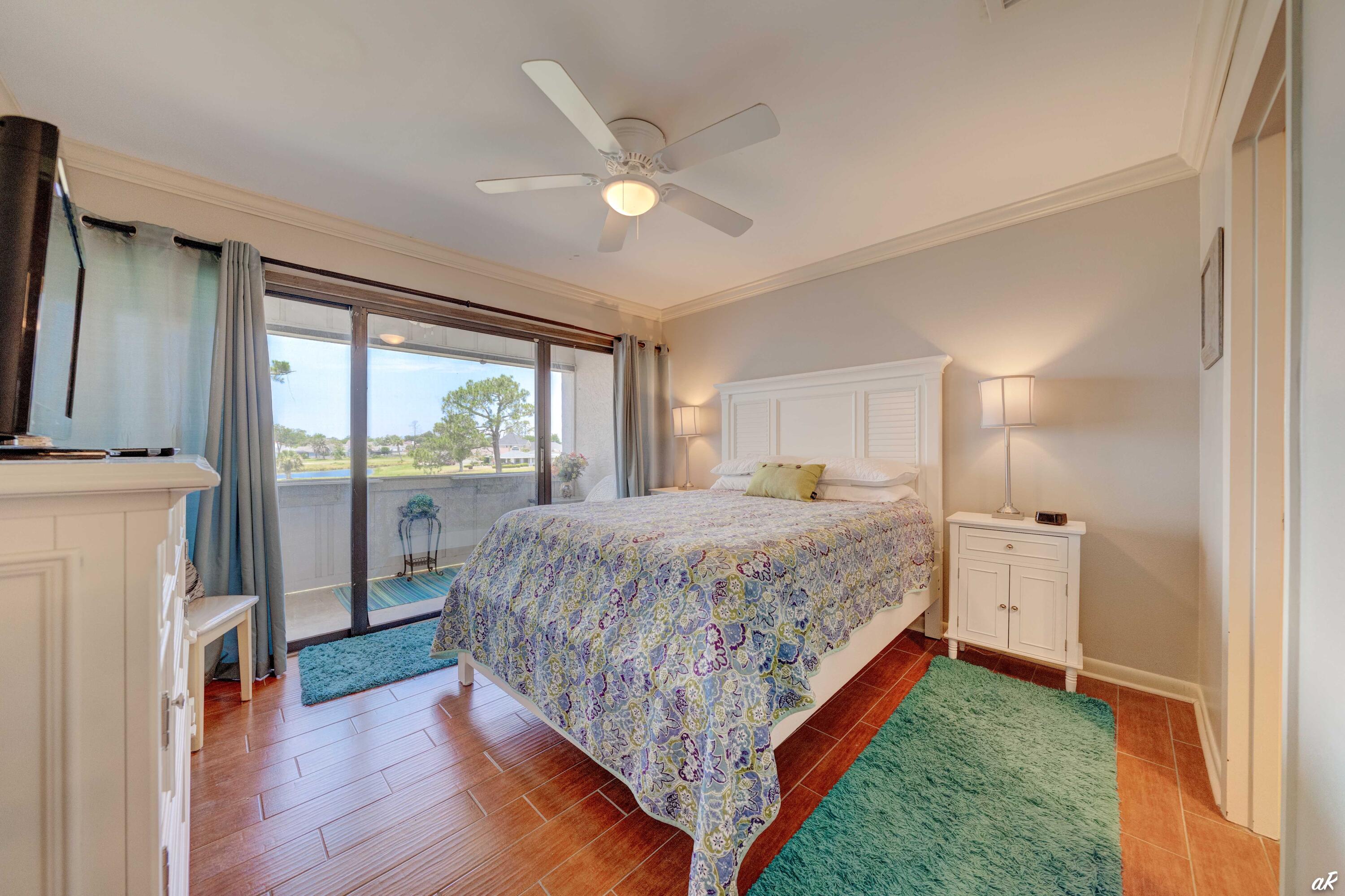 4300 Bay Point Road, Unit 417 Panama City Beach, FL 32408 - Photo 19 of 35 a bedroom with a bed and a large window