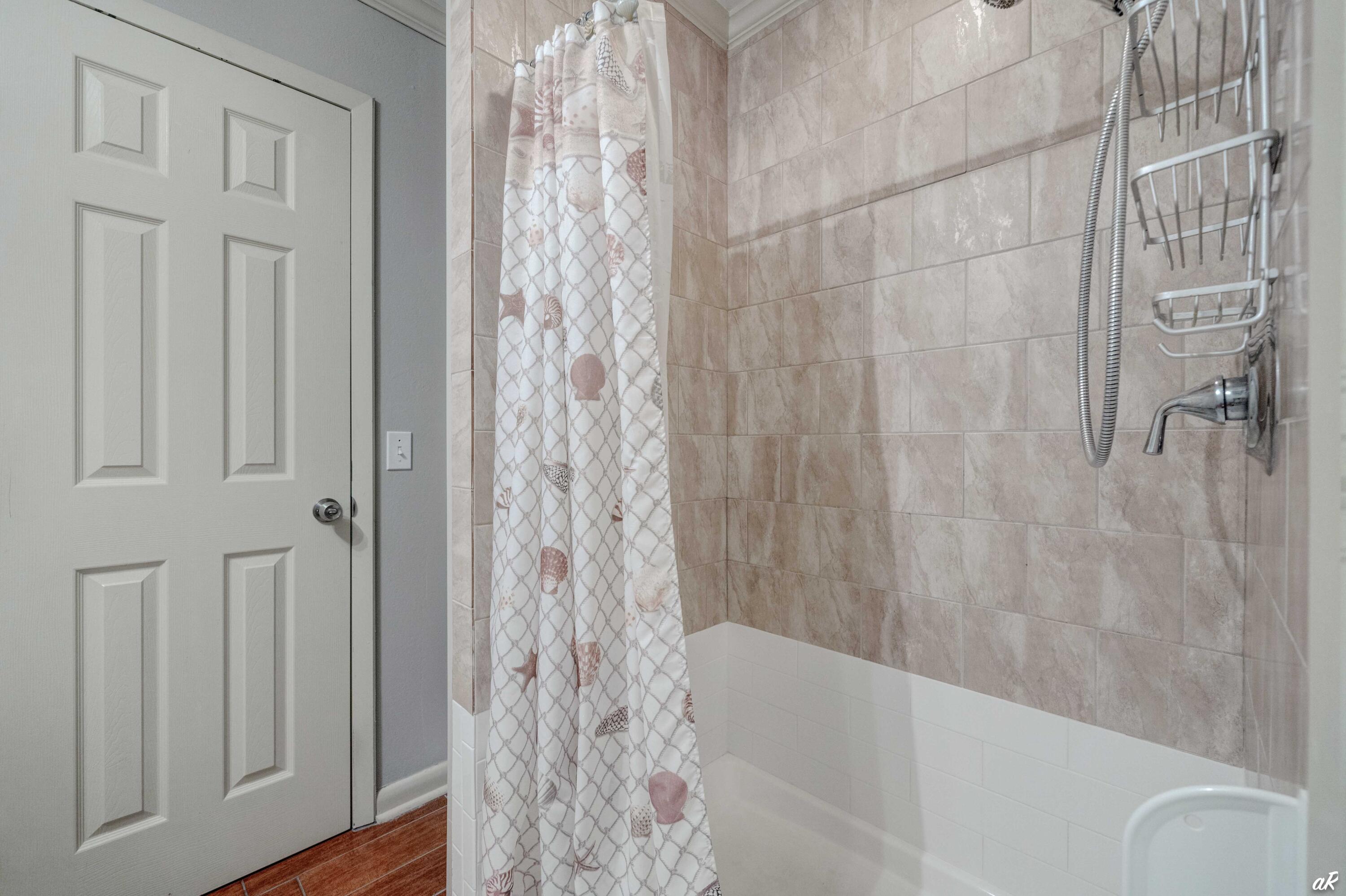 4300 Bay Point Road, Unit 417 Panama City Beach, FL 32408 - Photo 22 of 35 a bathroom with a bathtub and shower