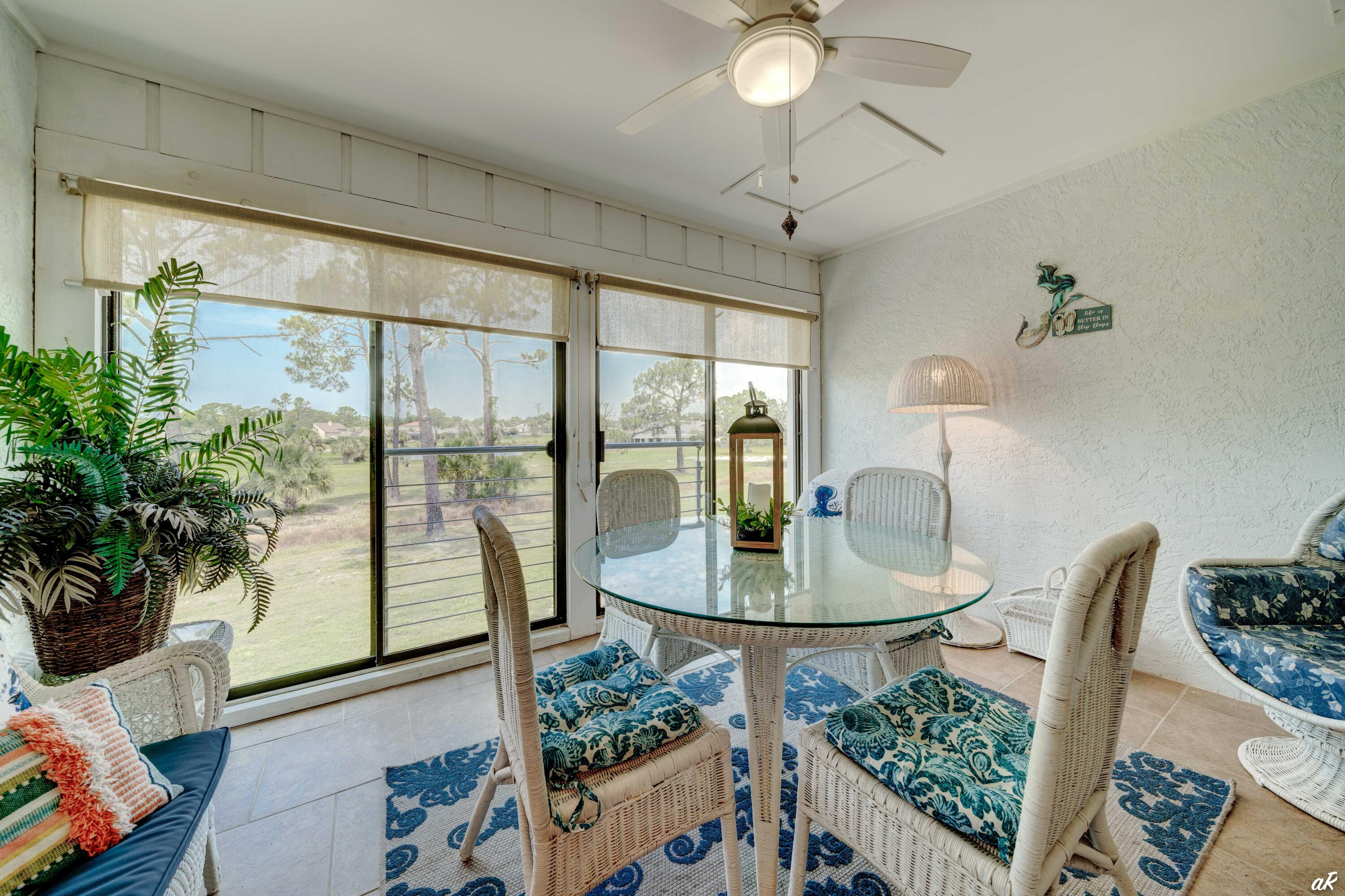 4300 Bay Point Road, Unit 417 Panama City Beach, FL 32408 - Photo 26 of 35 a dining room with furniture and a floor to ceiling window