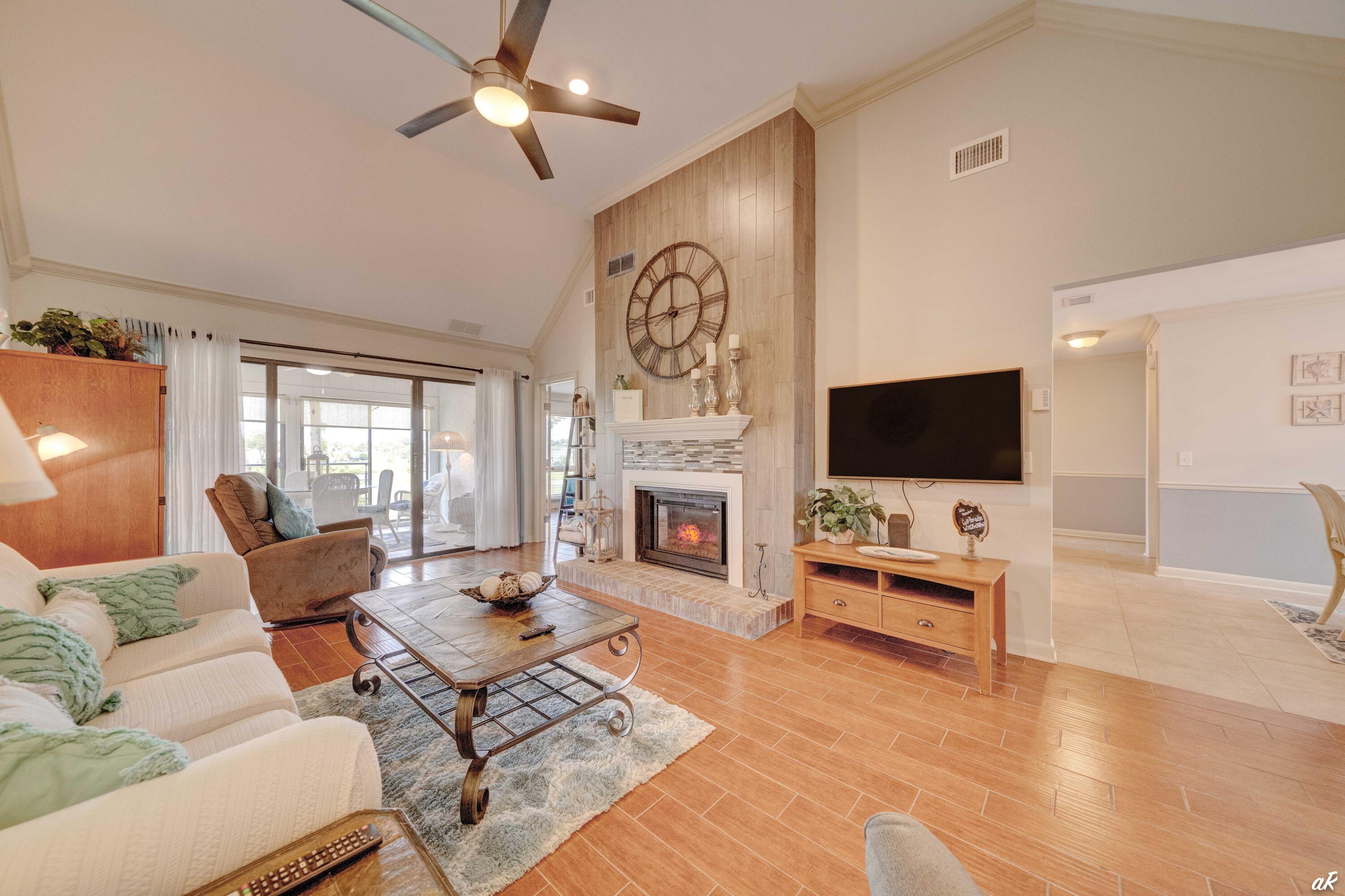 4300 Bay Point Road, Unit 417 Panama City Beach, FL 32408 - Photo 4 of 35 a living room with furniture fireplace and flat screen tv