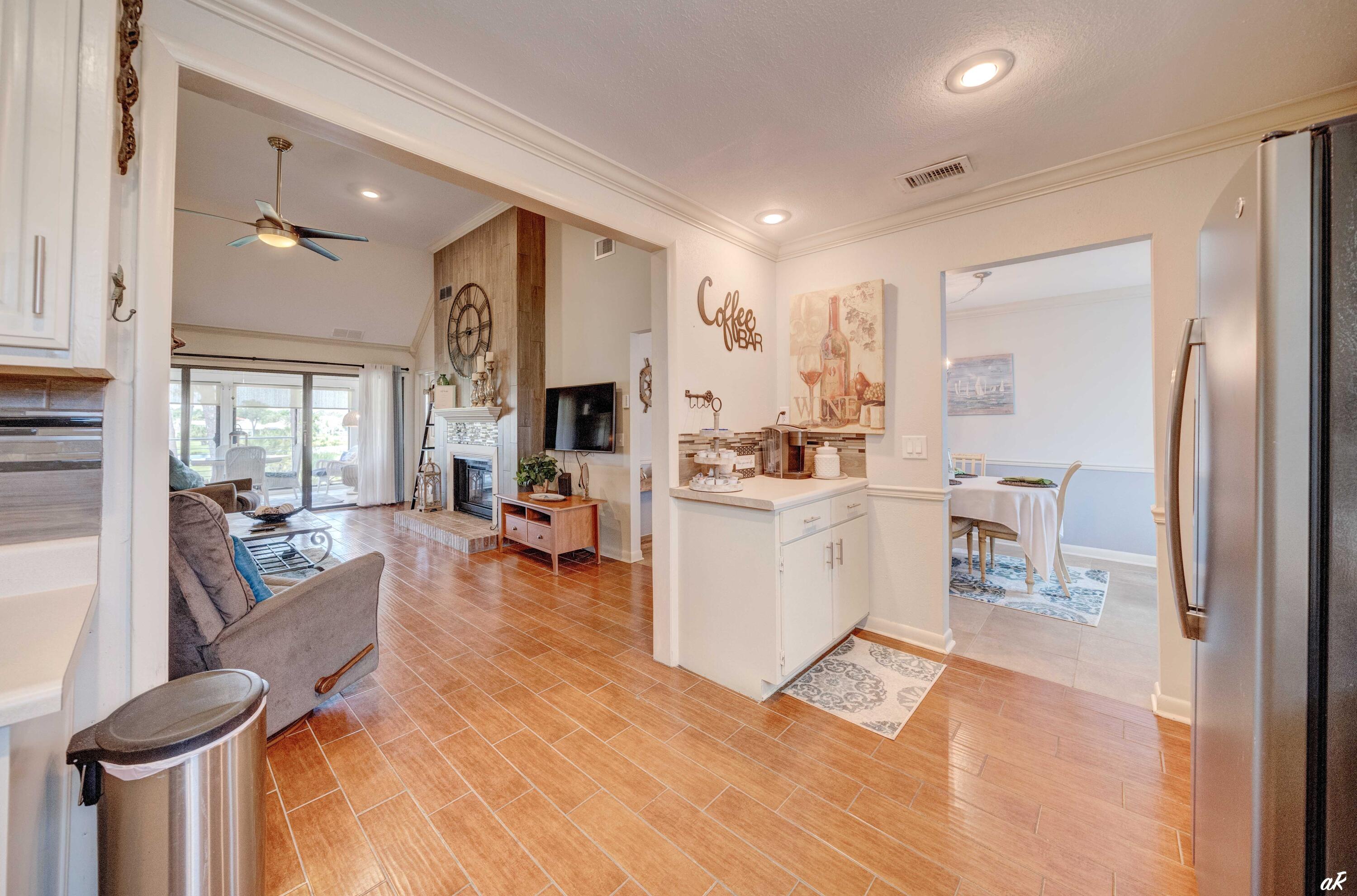 4300 Bay Point Road, Unit 417 Panama City Beach, FL 32408 - Photo 6 of 35 a view of living room kitchen with furniture and wooden floor