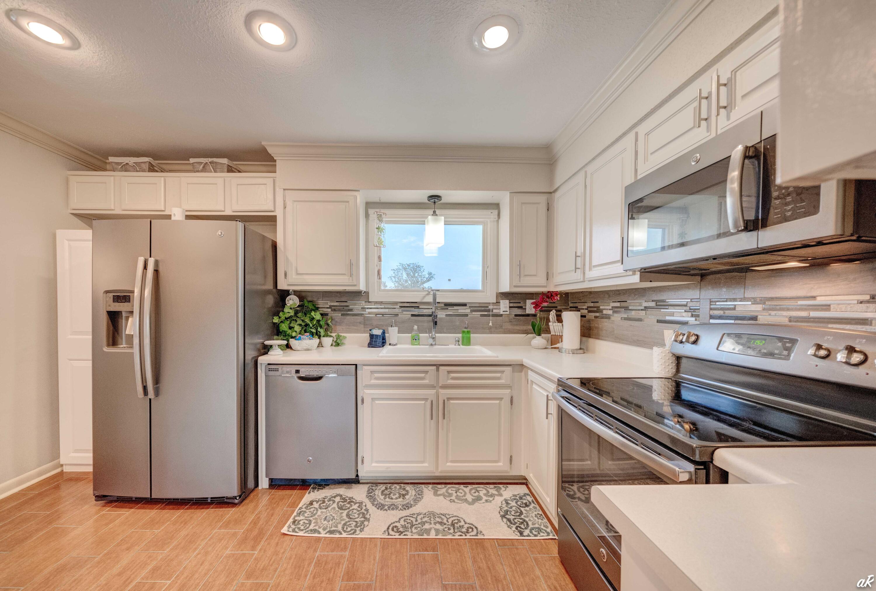4300 Bay Point Road, Unit 417 Panama City Beach, FL 32408 - Photo 7 of 35 a kitchen with stainless steel appliances a refrigerator sink and cabinets