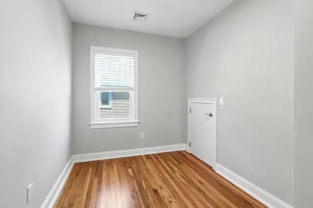 a view of a room with wooden floor and window