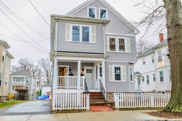 a view of a brick house with many windows