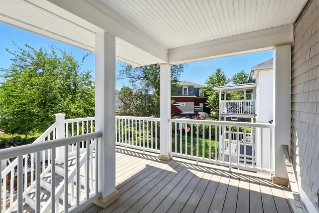 a view of a balcony with wooden floor