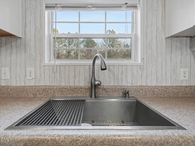 a spacious bathroom with a tub sink and mirror