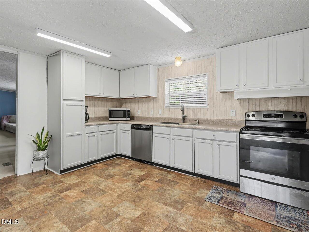 523 County Line Road Manson, NC 27553 - Photo 21 of 70 a kitchen with white cabinets and white appliances