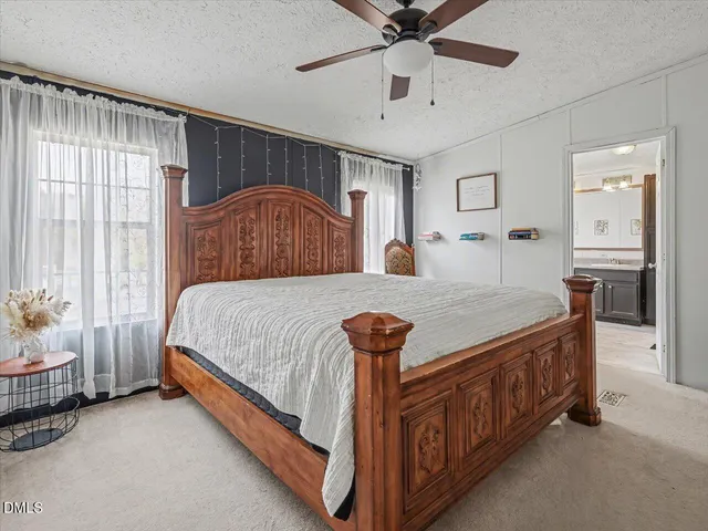 a bedroom with bed and a window