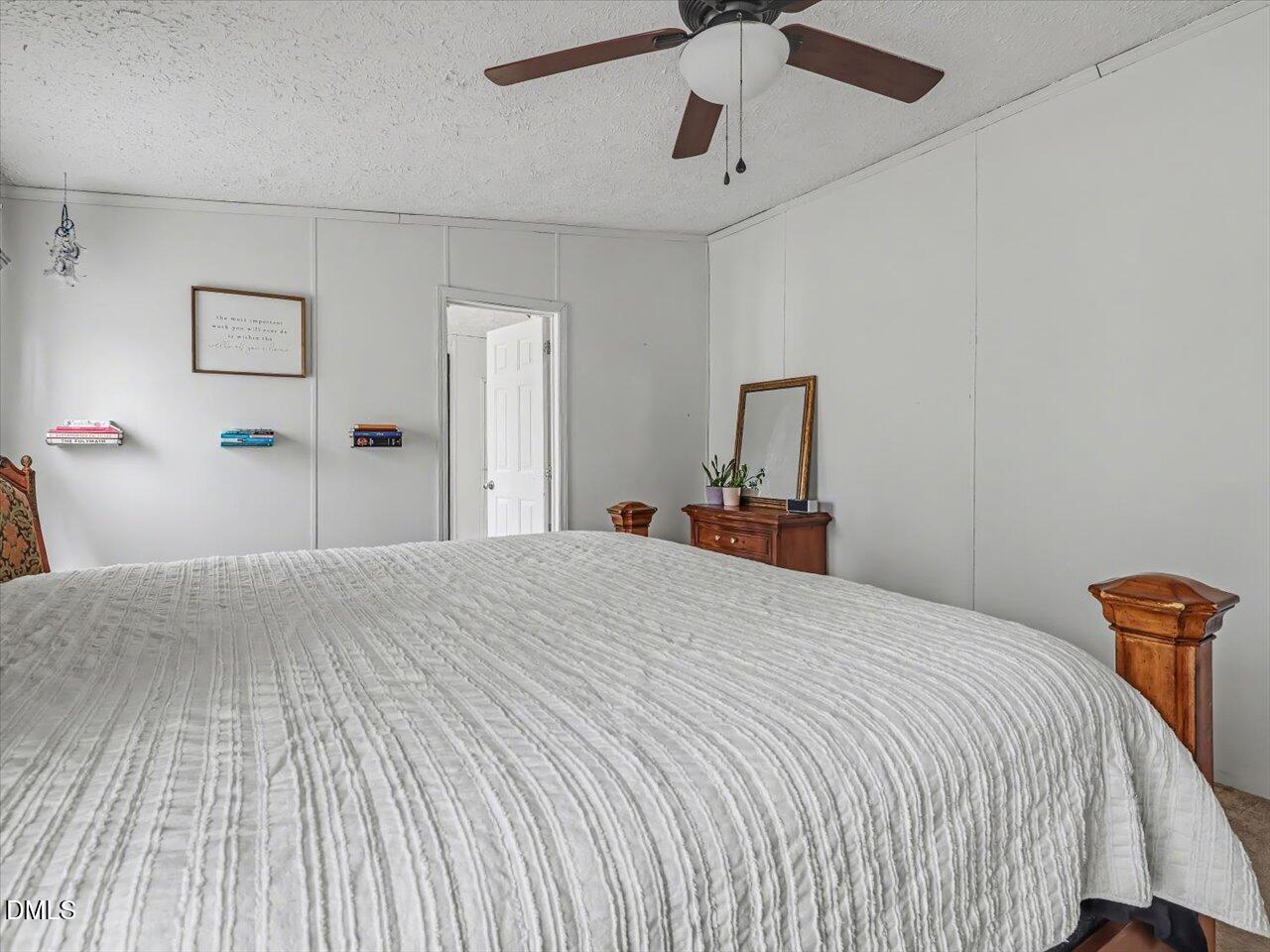 523 County Line Road Manson, NC 27553 - Photo 28 of 70 a bedroom with a bed and a chandelier