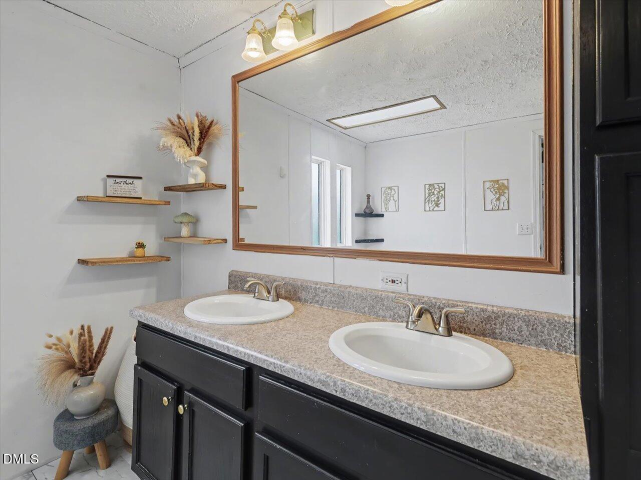 523 County Line Road Manson, NC 27553 - Photo 31 of 70 a bathroom with a granite countertop sink and a mirror