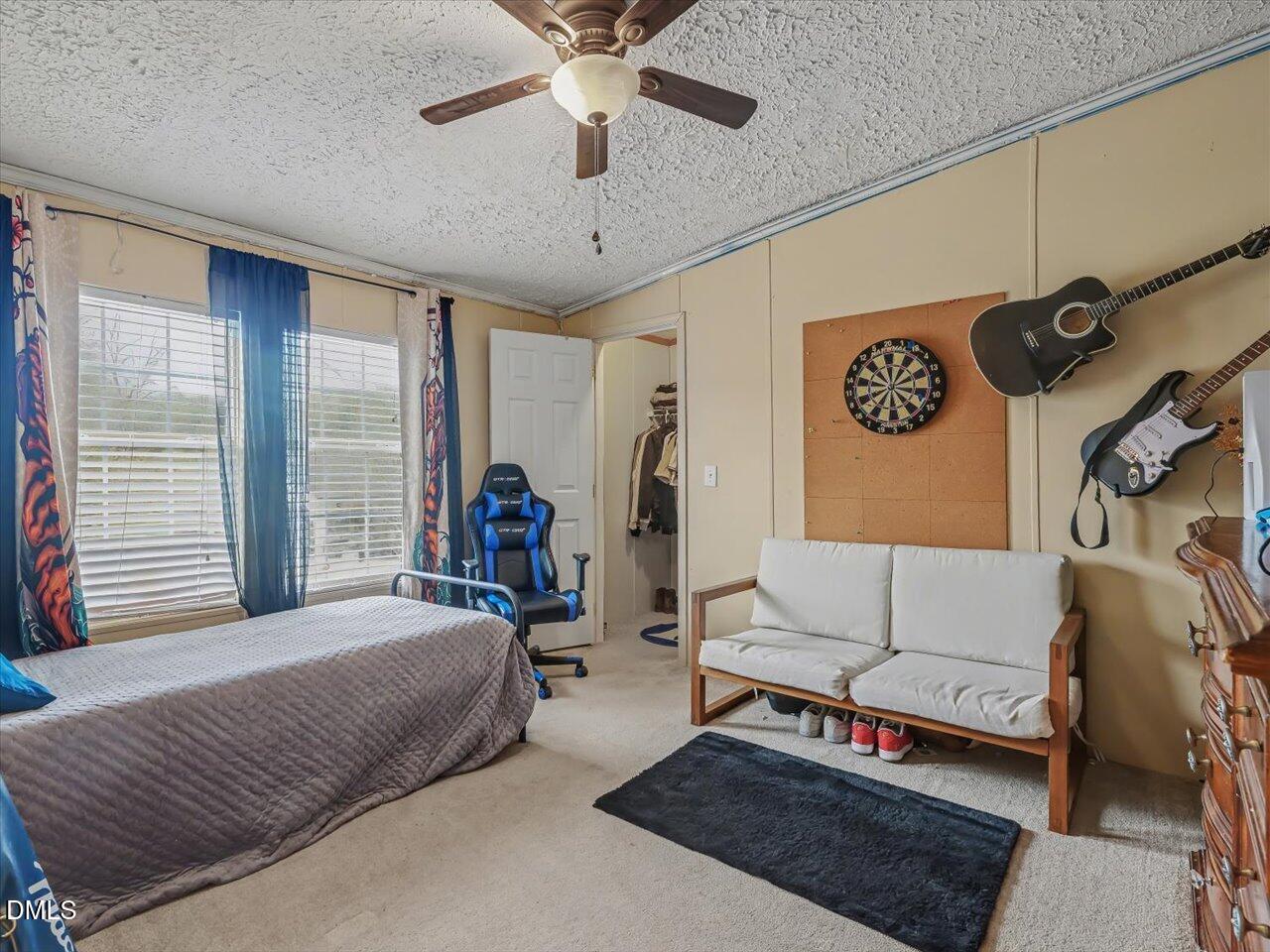 523 County Line Road Manson, NC 27553 - Photo 32 of 70 a bedroom with a bed couch and a window