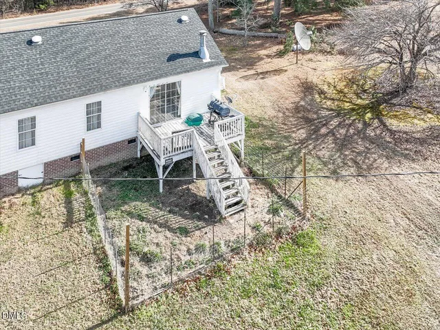 an aerial view of house with yard and mountain view
