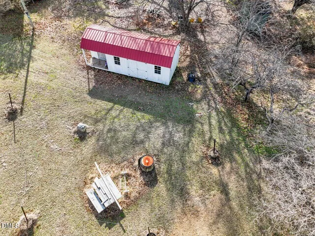 an aerial view of house with yard and mountain view