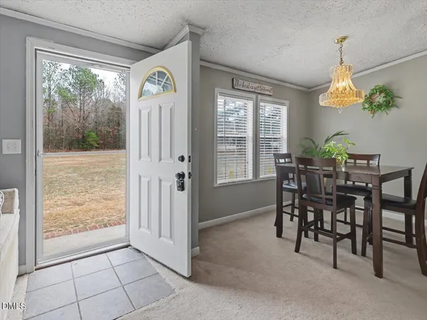 a dining room with furniture and a chandelier