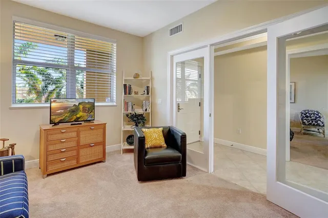 a view of a balcony with dining table and chairs potted plants