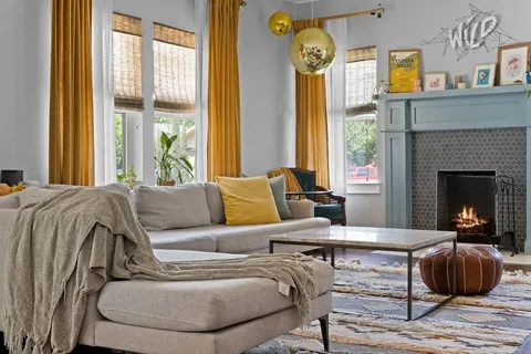 a living room with furniture and a fireplace