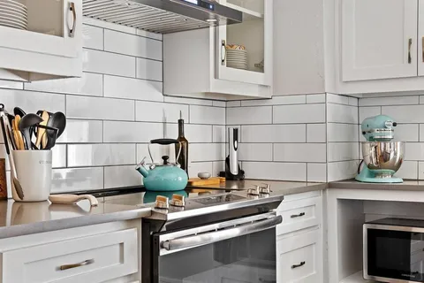 a kitchen with a stove and cabinets