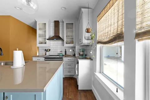 a kitchen with stainless steel appliances granite countertop a stove a sink and a refrigerator