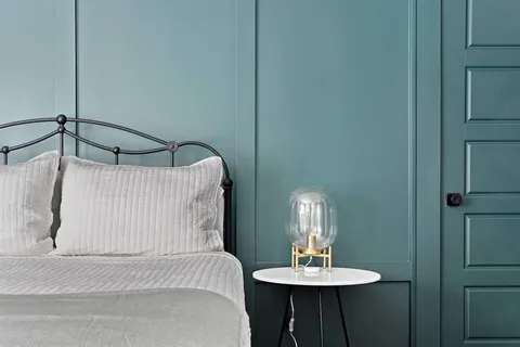 a bedroom with a bed and a table