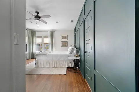 a very nice looking room with a large window and wooden floor