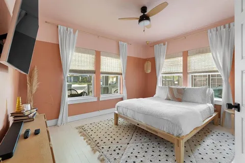 a bedroom with a large bed and a window