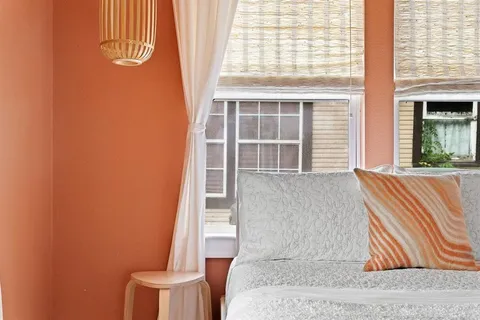 a living room with a couch and windows