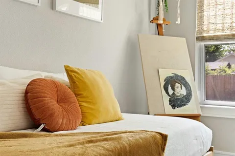 a bedroom with a bed and a window