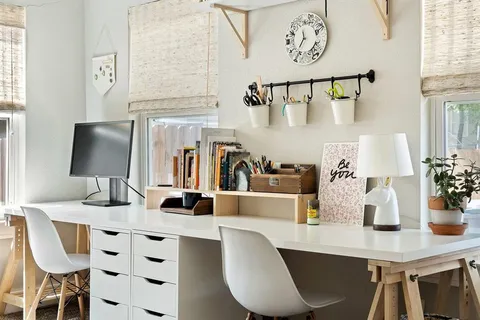 a living room with furniture a flat screen tv and windows