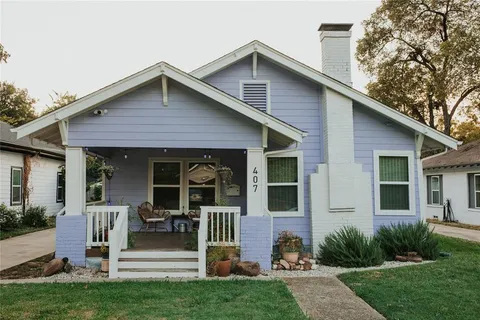 a front view of a house with a yard table and chairs