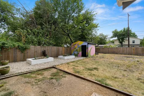 a bathroom with a sink and a covered with wooden fence