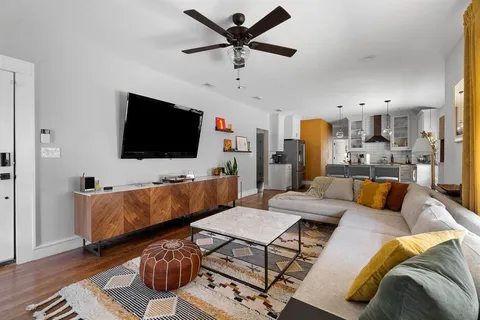a living room with furniture and a flat screen tv