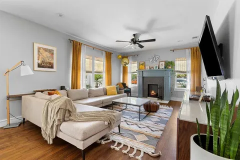 a living room with furniture fireplace and flat screen tv