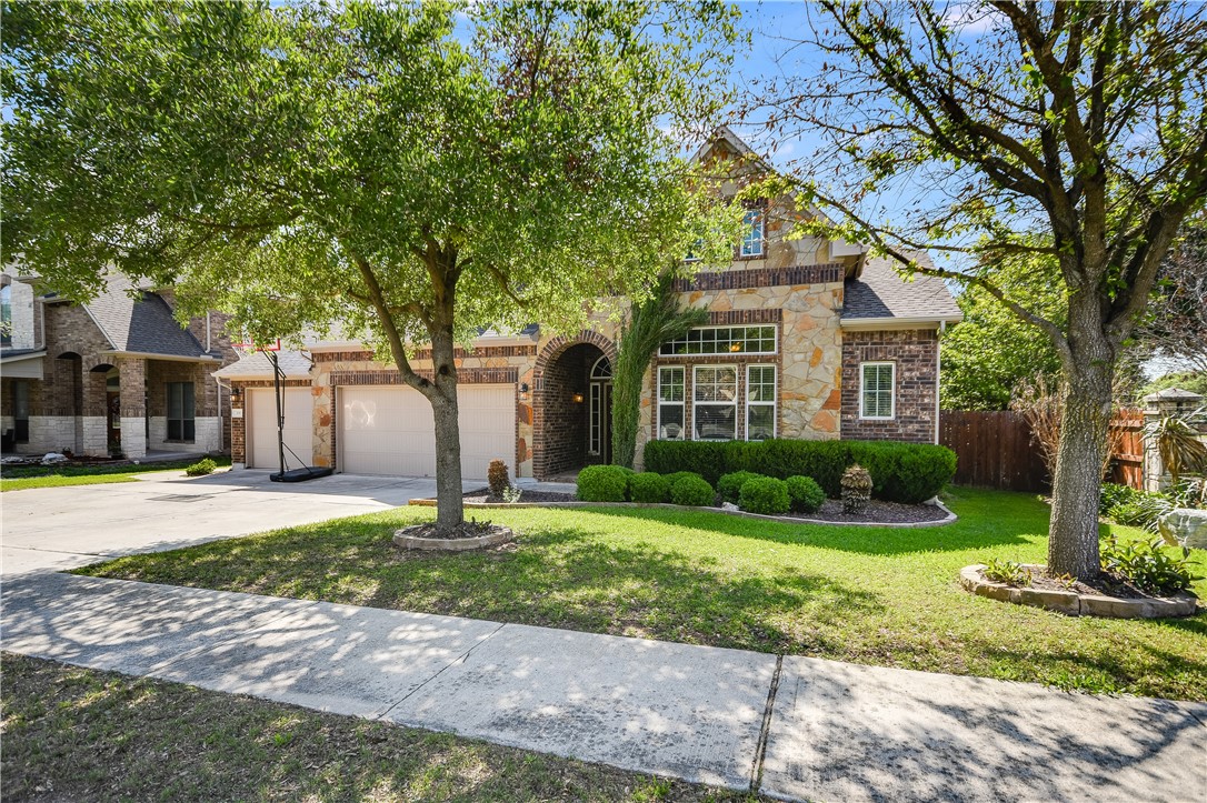 700 Nelson Ranch Road Cedar Park, TX 78613 - Photo 1 of 1 a white house that has a tree in front of it