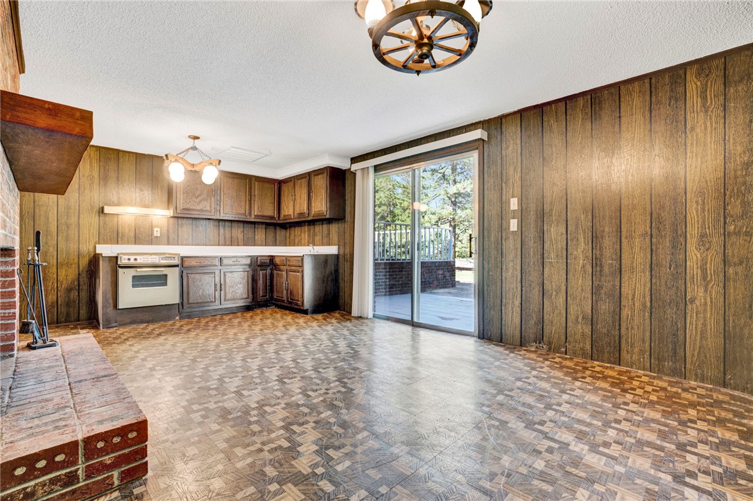 7876 Highway 11 Walhalla, SC 29691 - Photo 31 of 35 A spacious room offers an oven, a cozy fireplace, and direct patio access for indoor-outdoor living.
