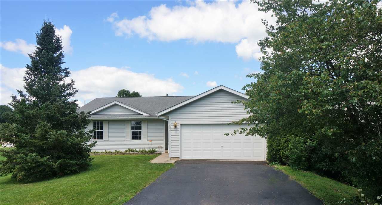 304 Rochester Road Northeast Poplar Grove, IL 61065 - Photo 1 of 23 a front view of a house with a yard and garage