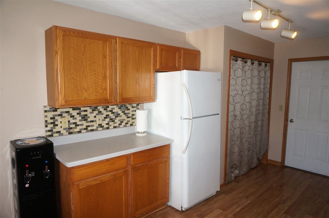 304 Rochester Road Northeast Poplar Grove, IL 61065 - Photo 12 of 23 a kitchen with a refrigerator and a stove top oven